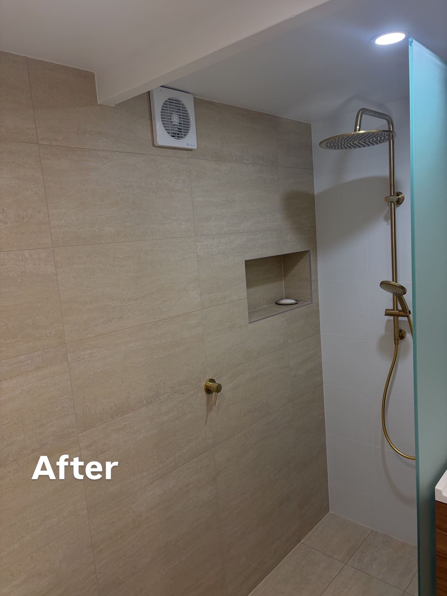 Bathroom after renovation with modern walk-in shower and clean tiling
